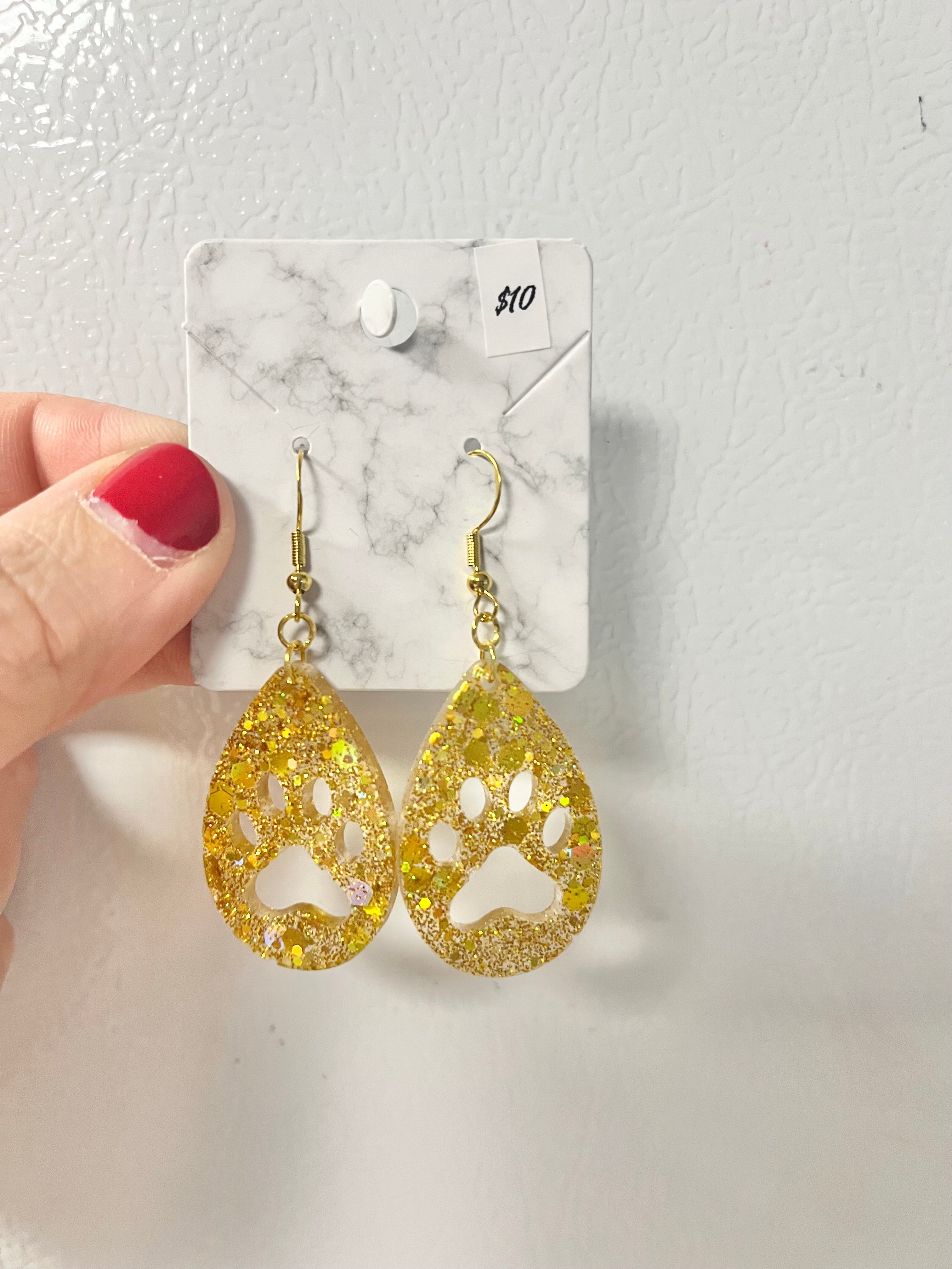 Bright gold paw print earrings with holographic glitter