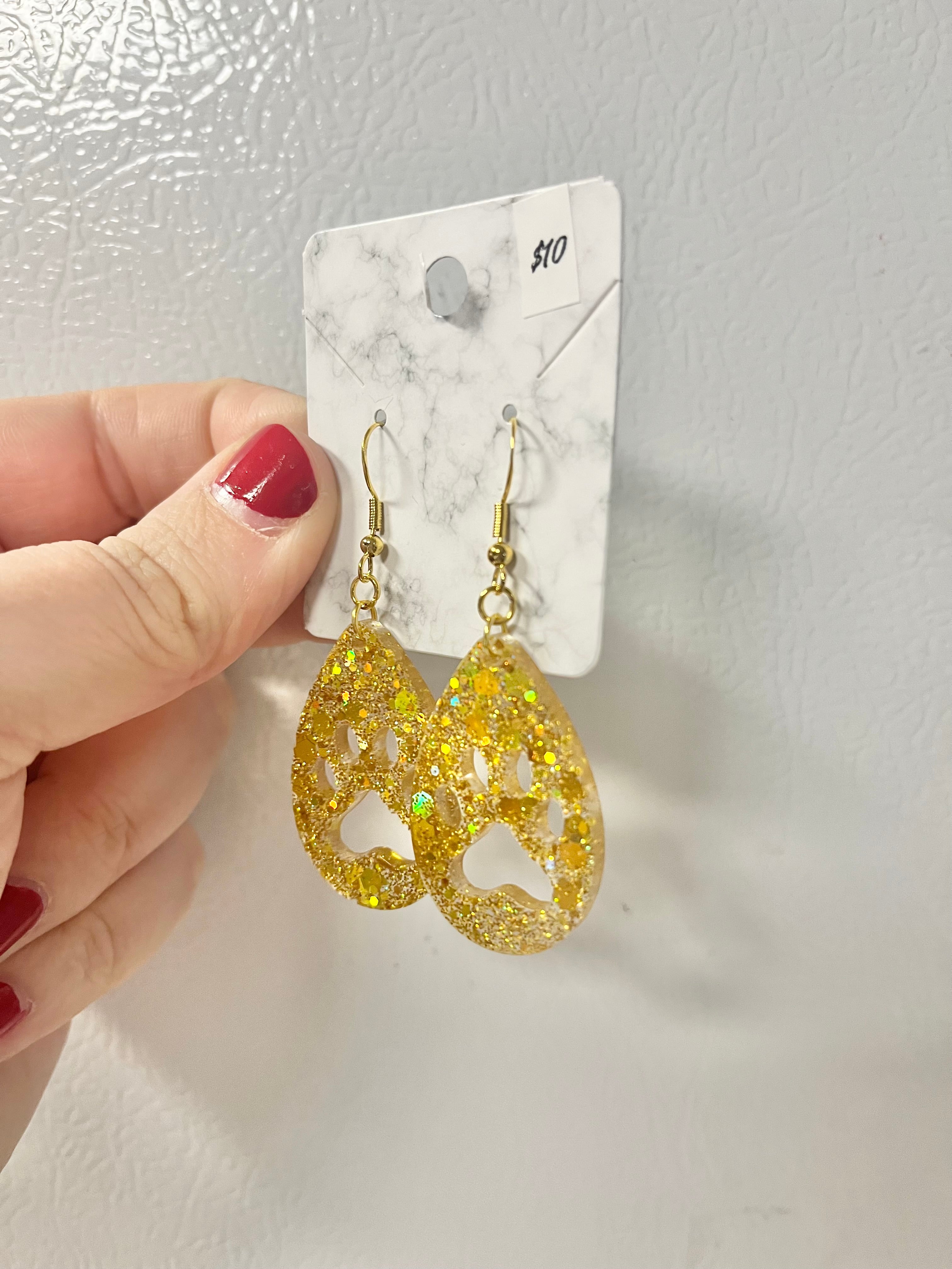 Bright gold paw print earrings with holographic glitter