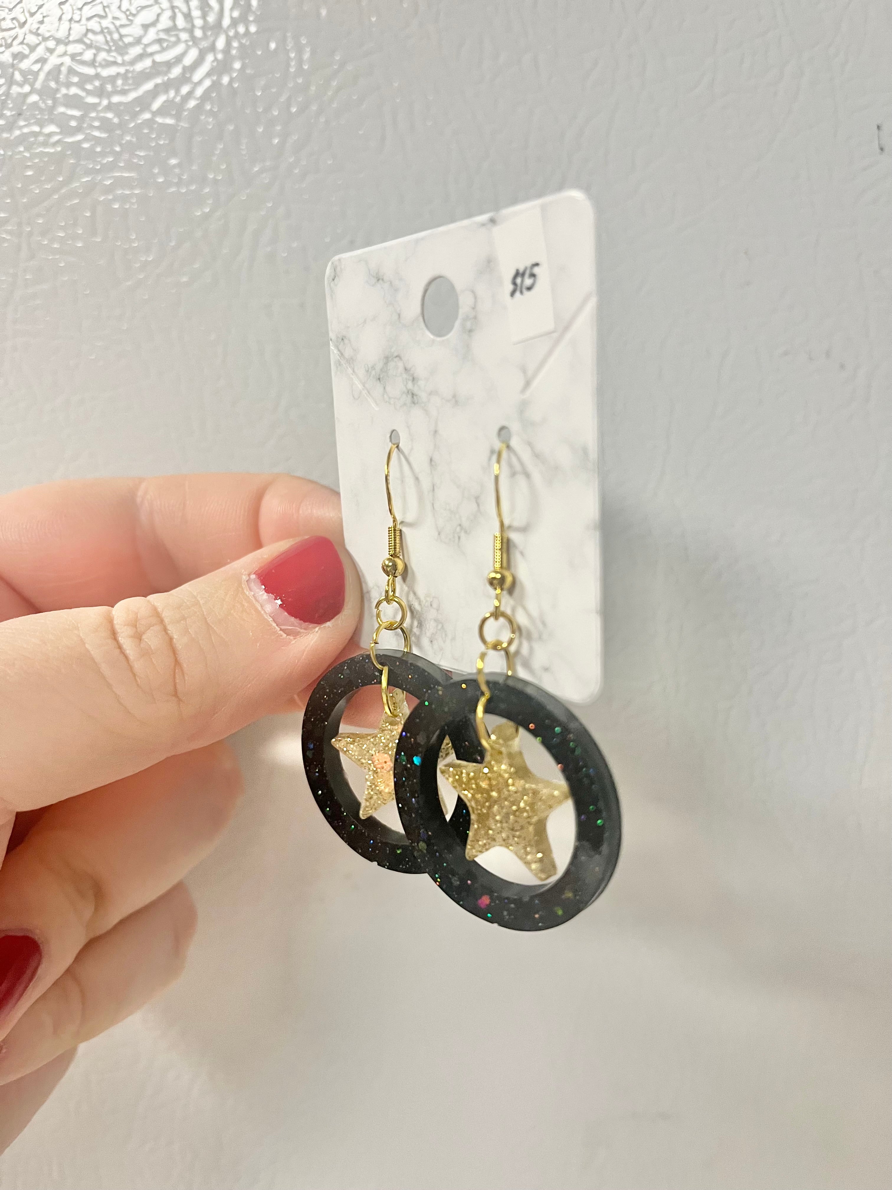 Black and gold star earrings