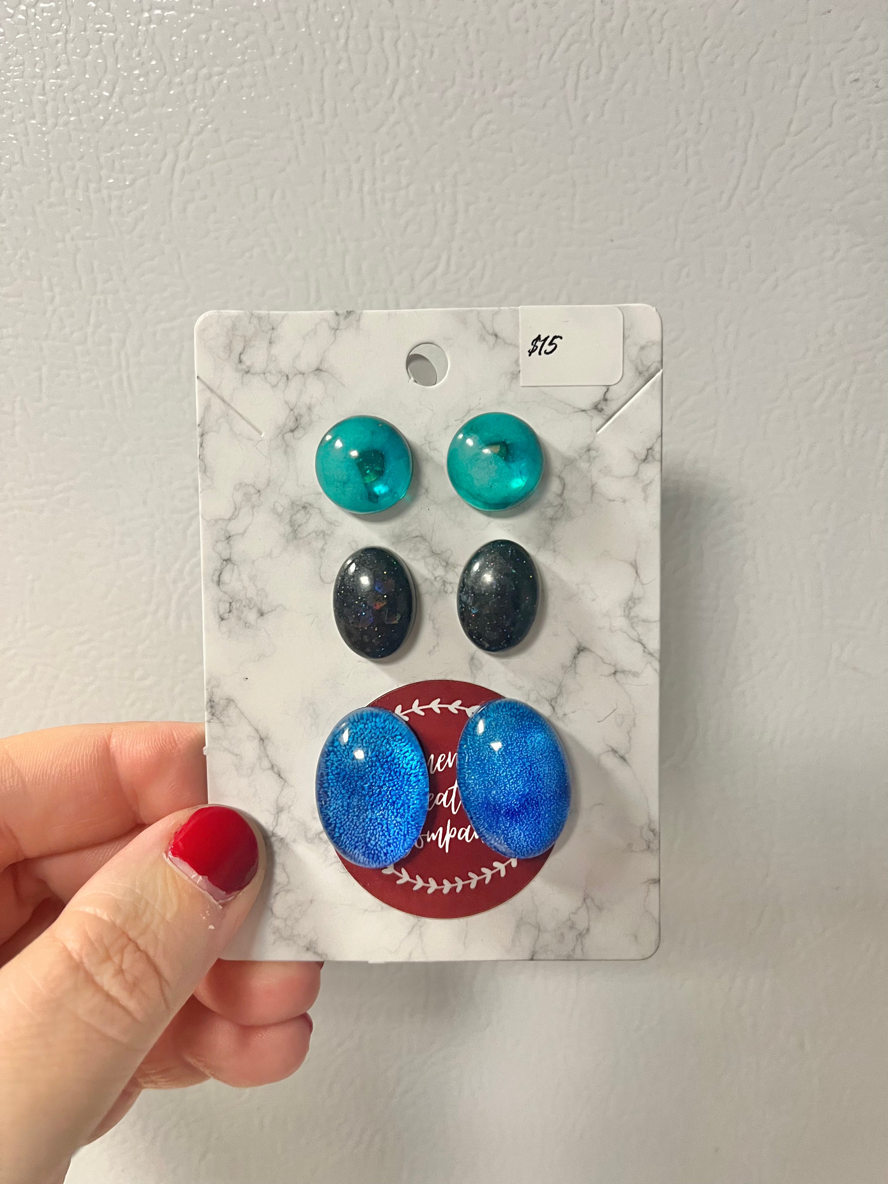 Green, black, and blue earrings