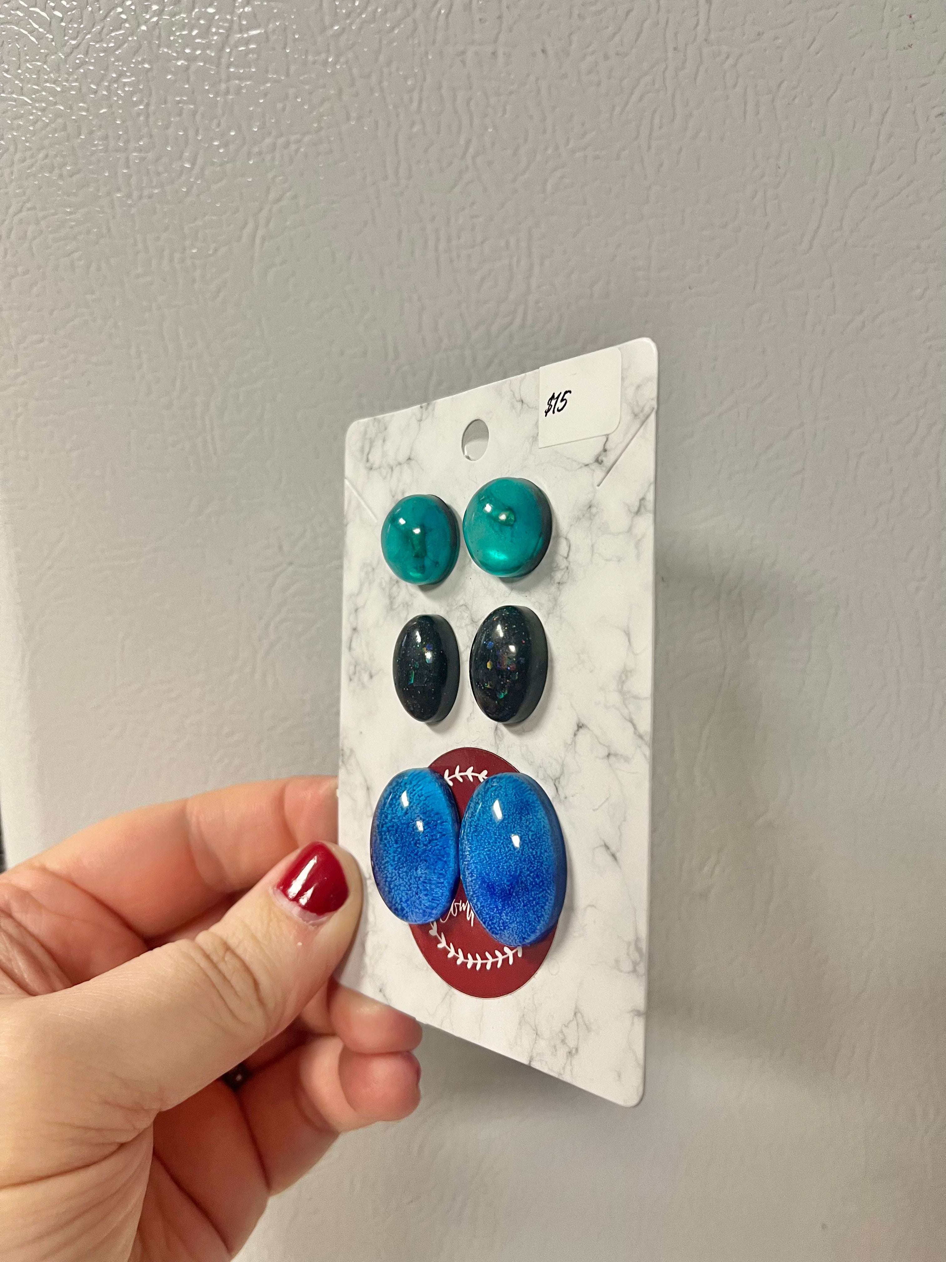 Green, black, and blue earrings