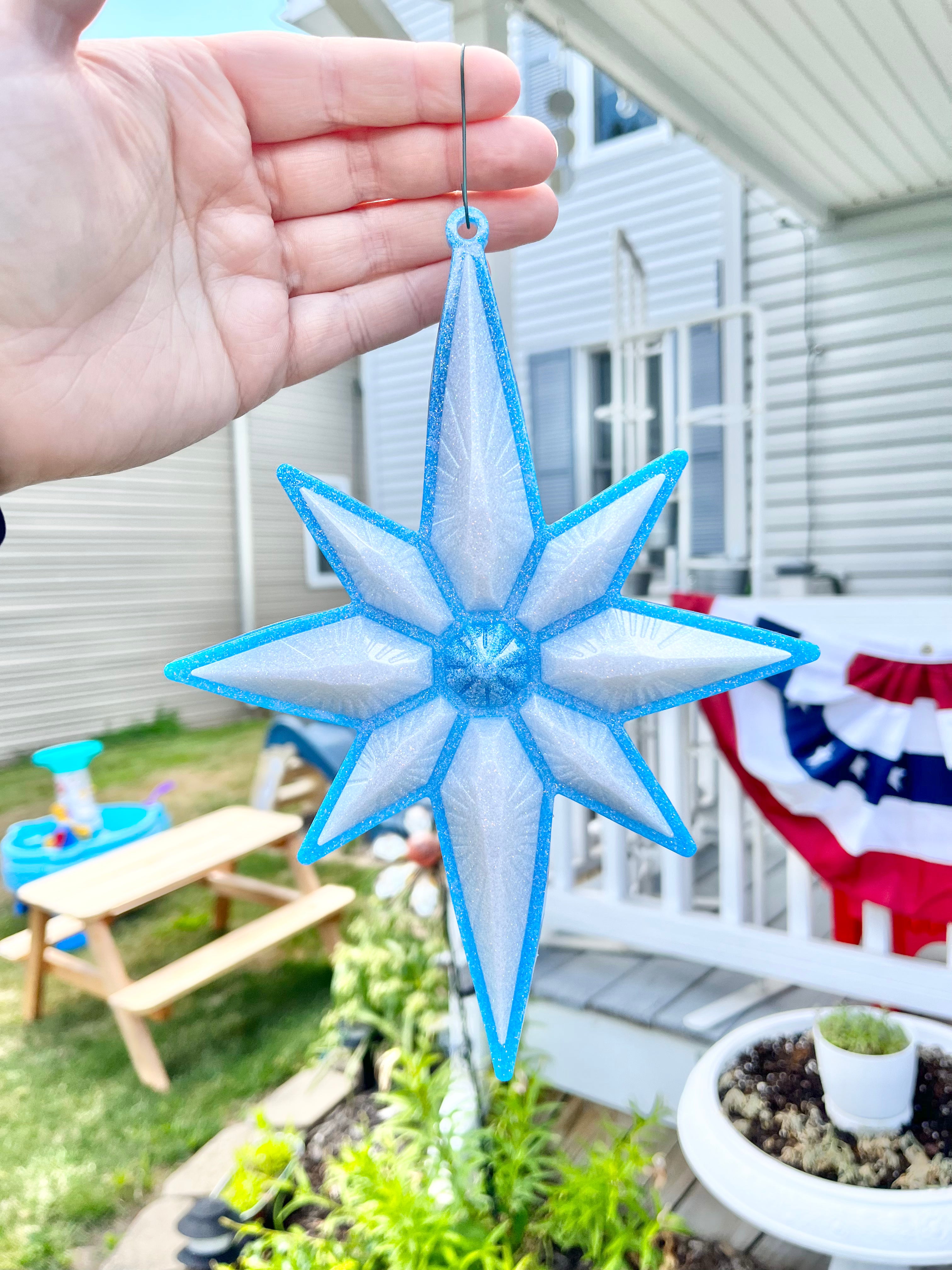 Blue and white North Star Christmas ornament