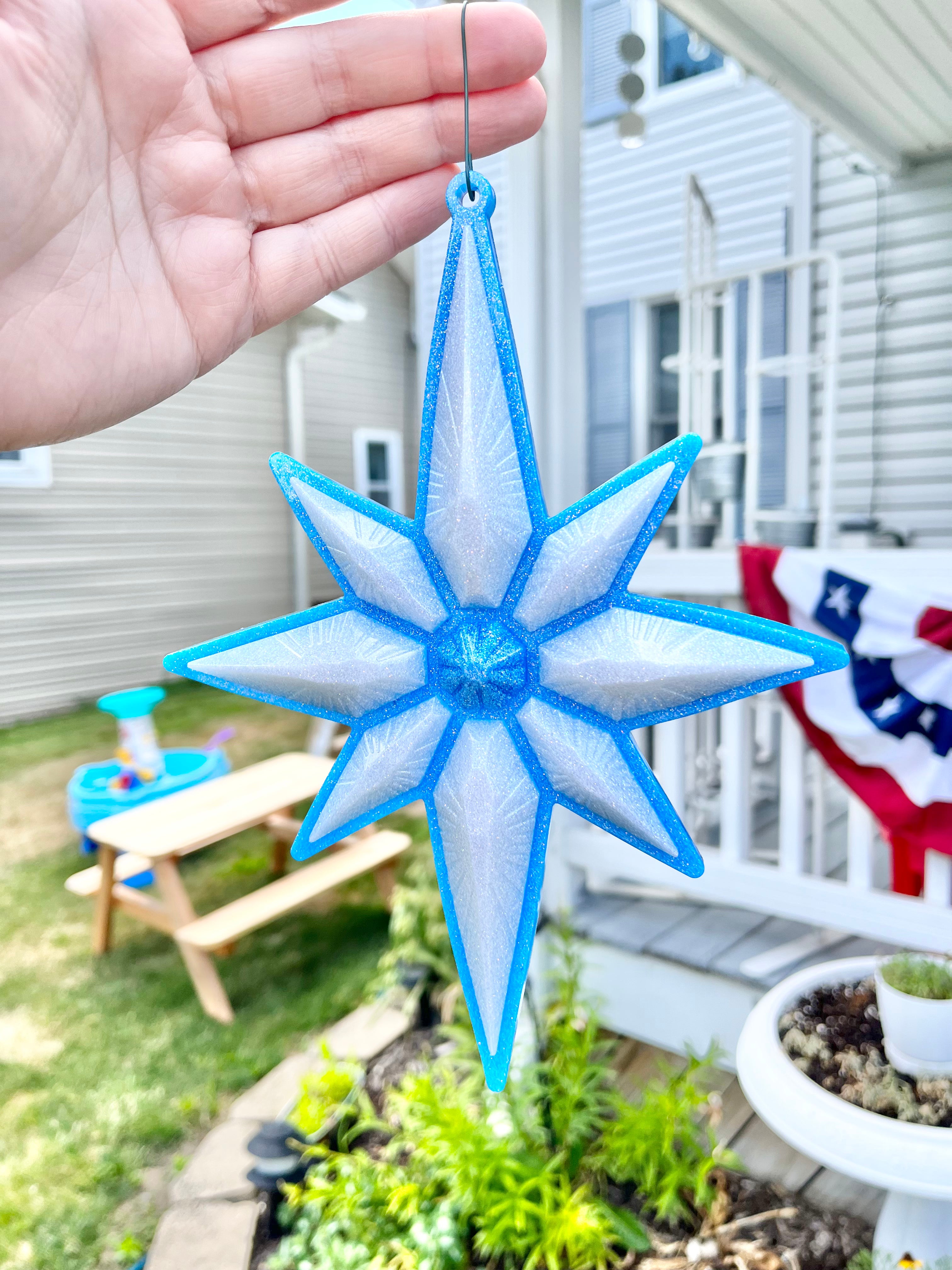 Blue and white North Star Christmas ornament