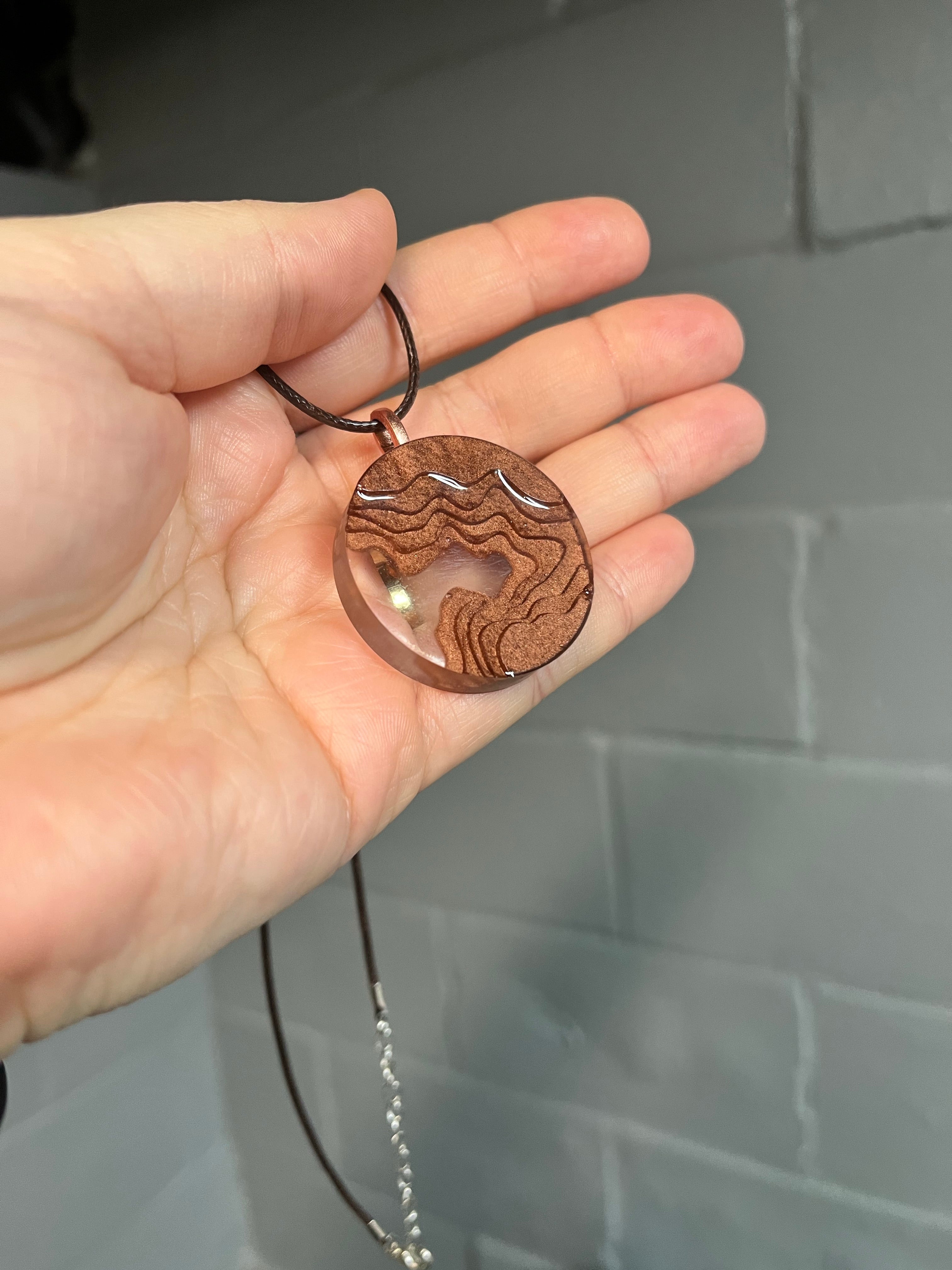 Brown circular landscape pendant necklace