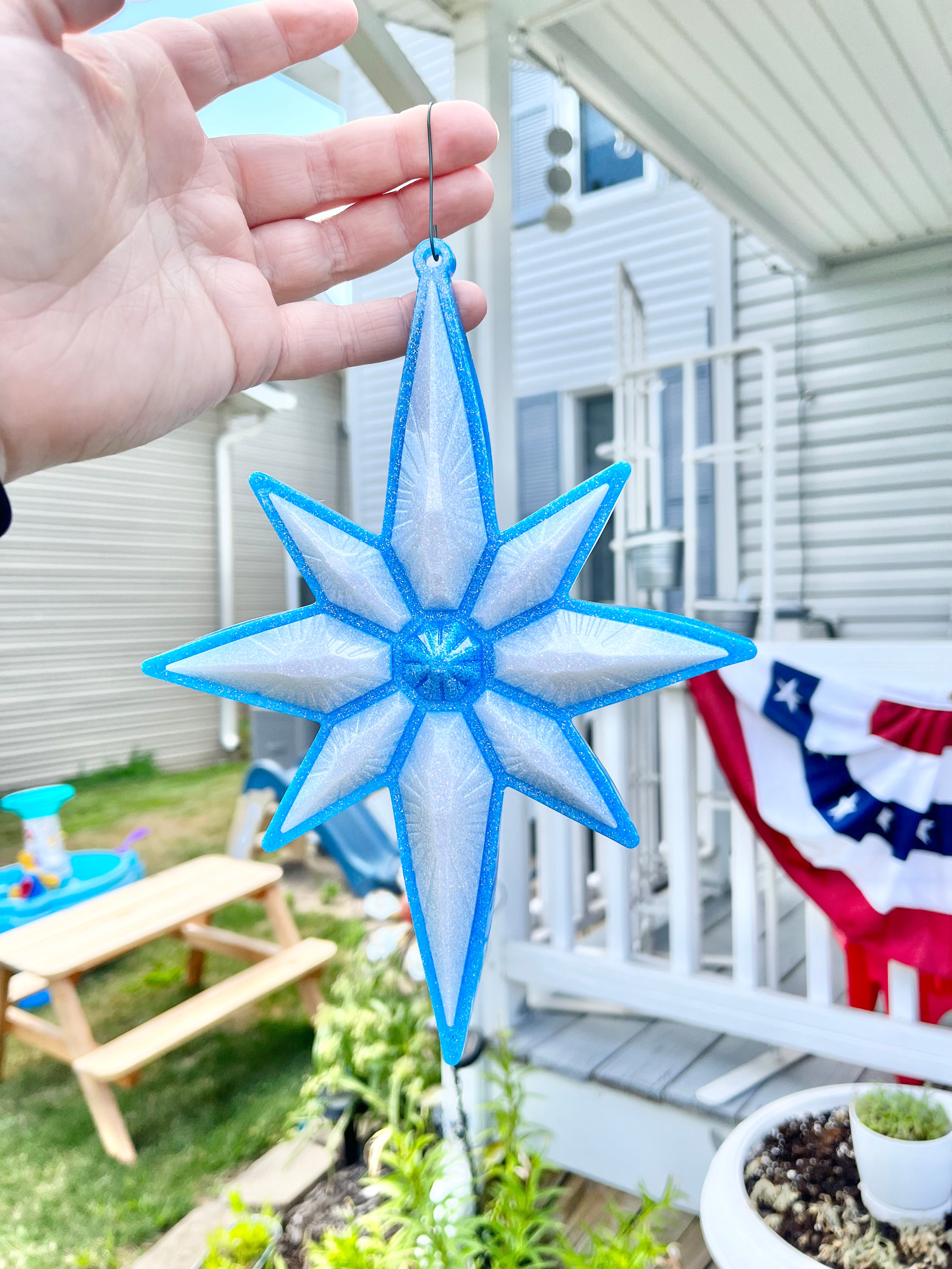 Blue and white North Star Christmas ornament