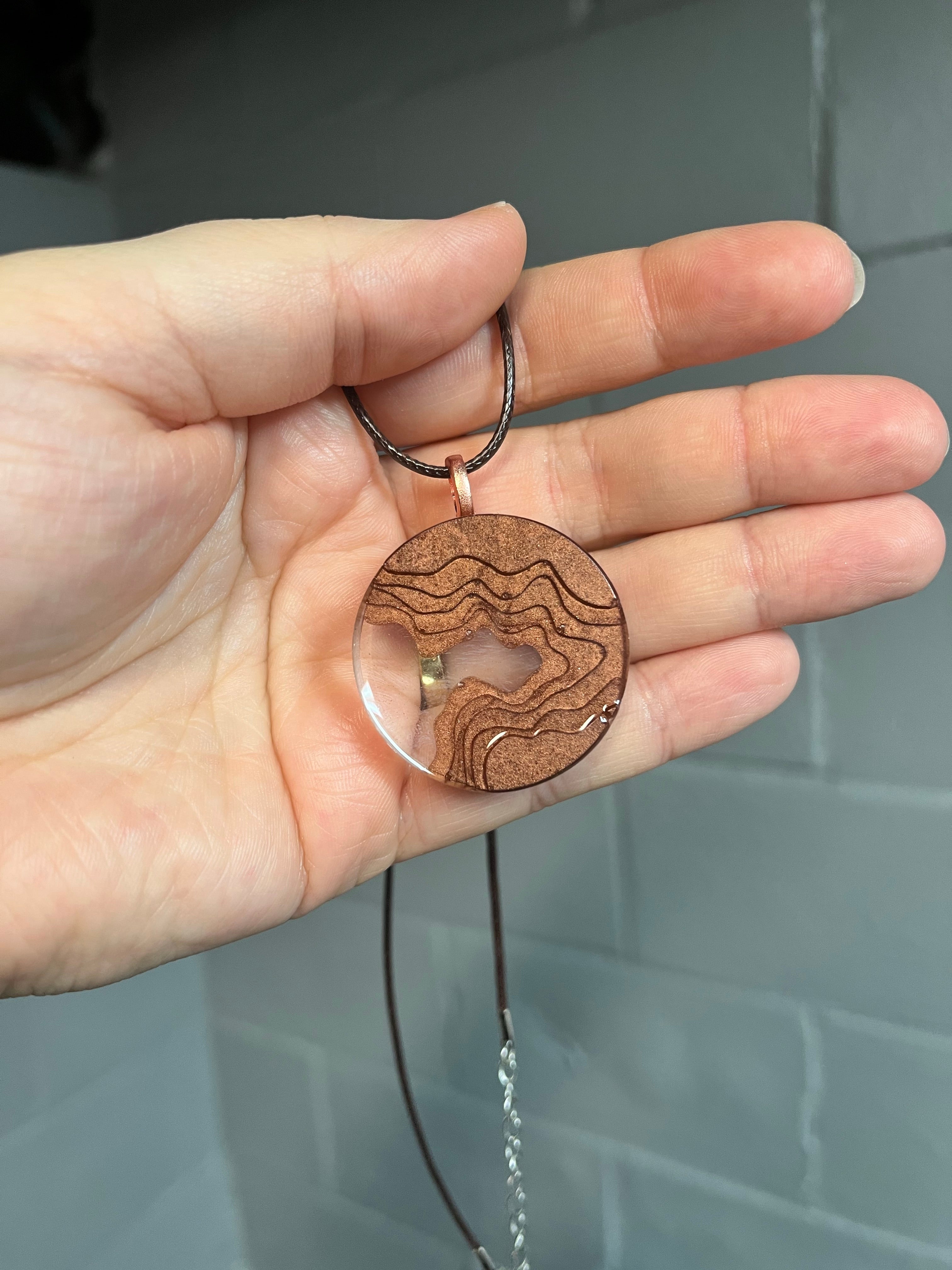 Brown circular landscape pendant necklace